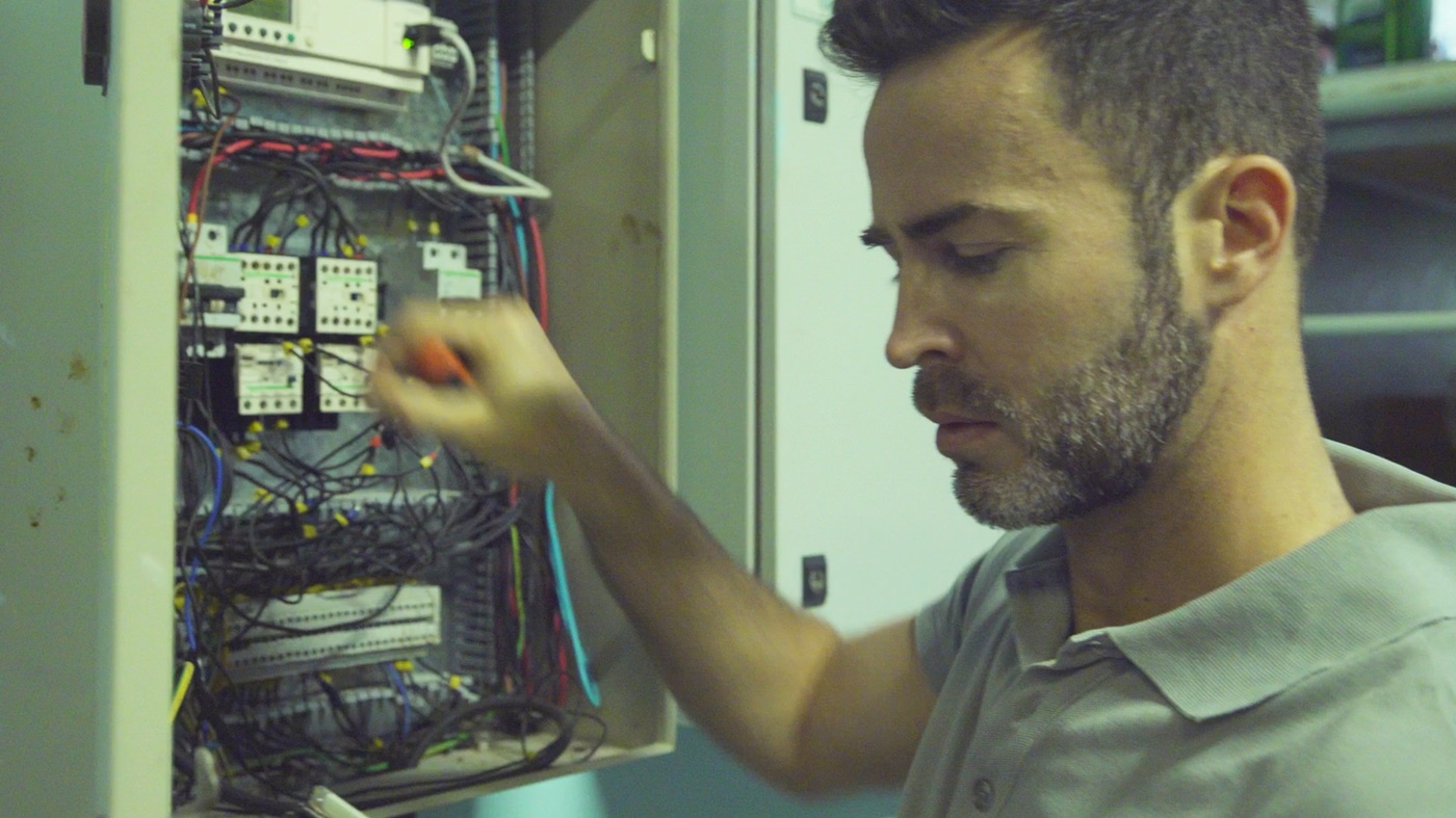 Electrician working on an electrical panel.