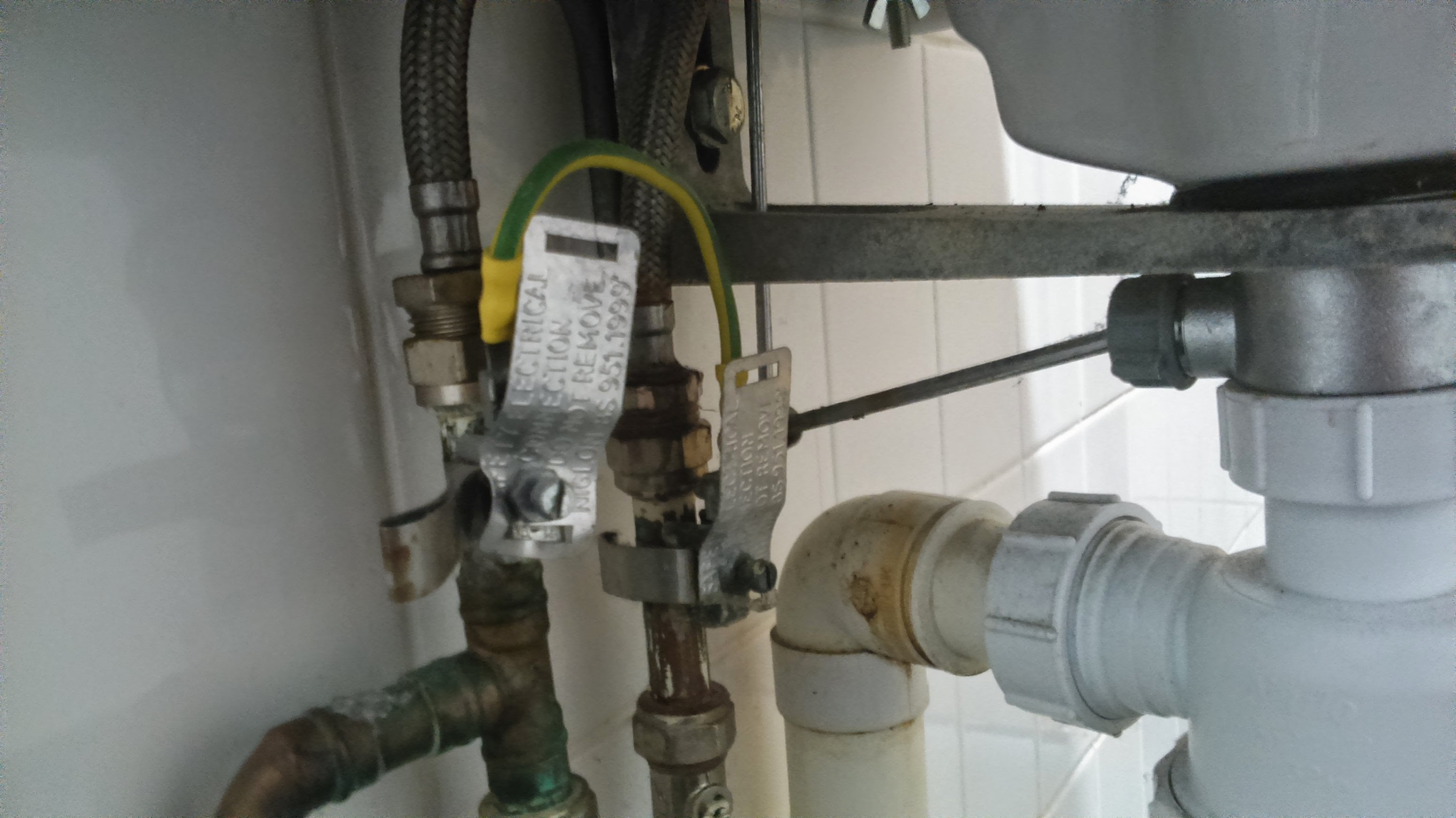 A close view of plumbing valves and connections during a repair.
